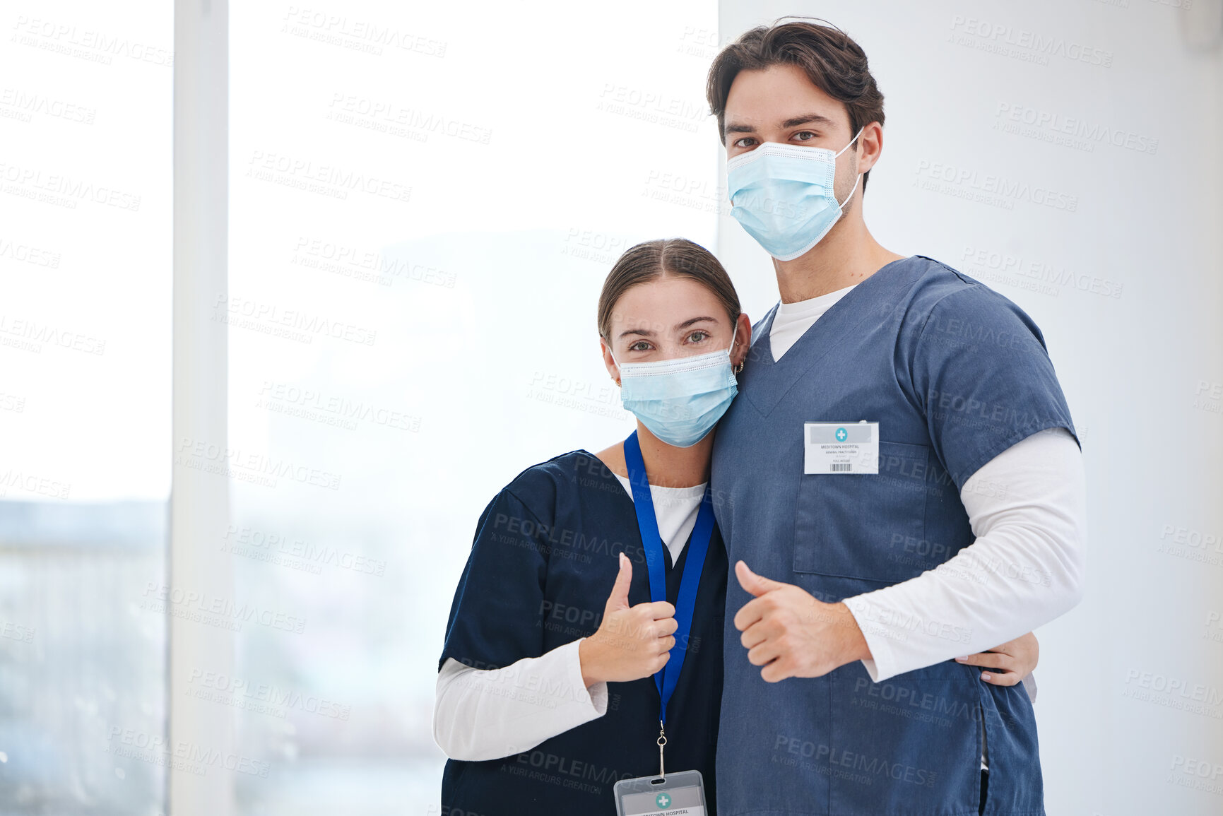 Buy stock photo Portrait, doctors and people hug, thumbs up or vote opinion for medical support, service agreement or job well done. Safety face mask, emoji like sign and surgeon team embrace, trust and yes feedback