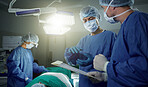 Collaboration, medical and doctors working on a surgery for healthcare treatment in a theatre room. Teamwork, career and professional surgeons doing an operation on a patient in a hospital or clinic.