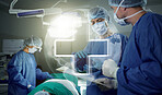Hologram, teamwork and doctors in a hospital for surgery together, working in theater to save a life. World healthcare, medical and a surgeon team in the operating room of a clinic for an operation