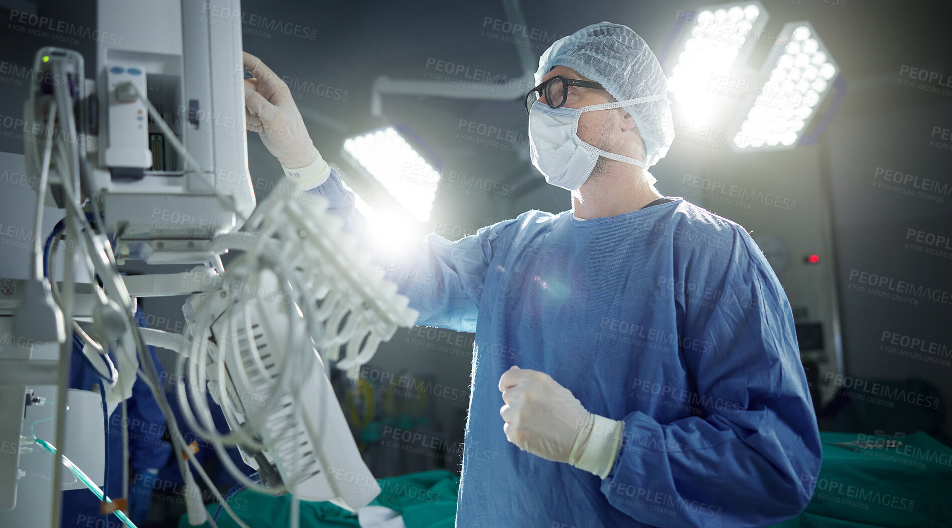 Buy stock photo Healthcare, monitor and vital with a doctor in theater getting ready for surgery in a hospital operating room. Medical, technology and equipment with a surgeon in a clinic as a medicine professional