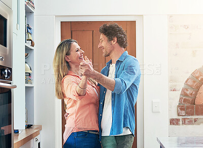 Buy stock photo Shot of a happy mature couple dancing together at home