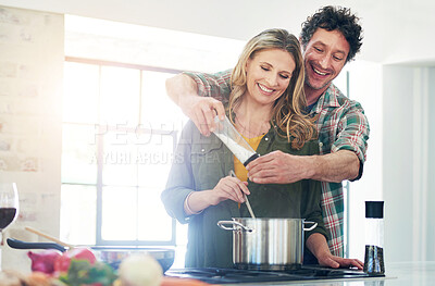 Buy stock photo Shot of a happy mature couple preparing a meal together at home
