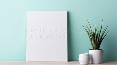 Canvas mockup against blue wall. Empty canvas on table top for your design.