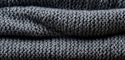 Close-up of grey folded fabric. Wool textile background.