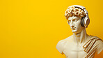 Sculpture or statue of David wearing headphones on yellow background