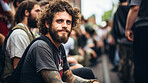 Street style portrait of smiling tattooed man in street. Alternative lifestyle concept.