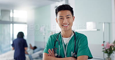 Face, happy nurse and Asian man with arms crossed in hospital for healthcare, wellness and medicine. Portrait, smile and confident medical worker, professional surgeon and expert employee in clinic