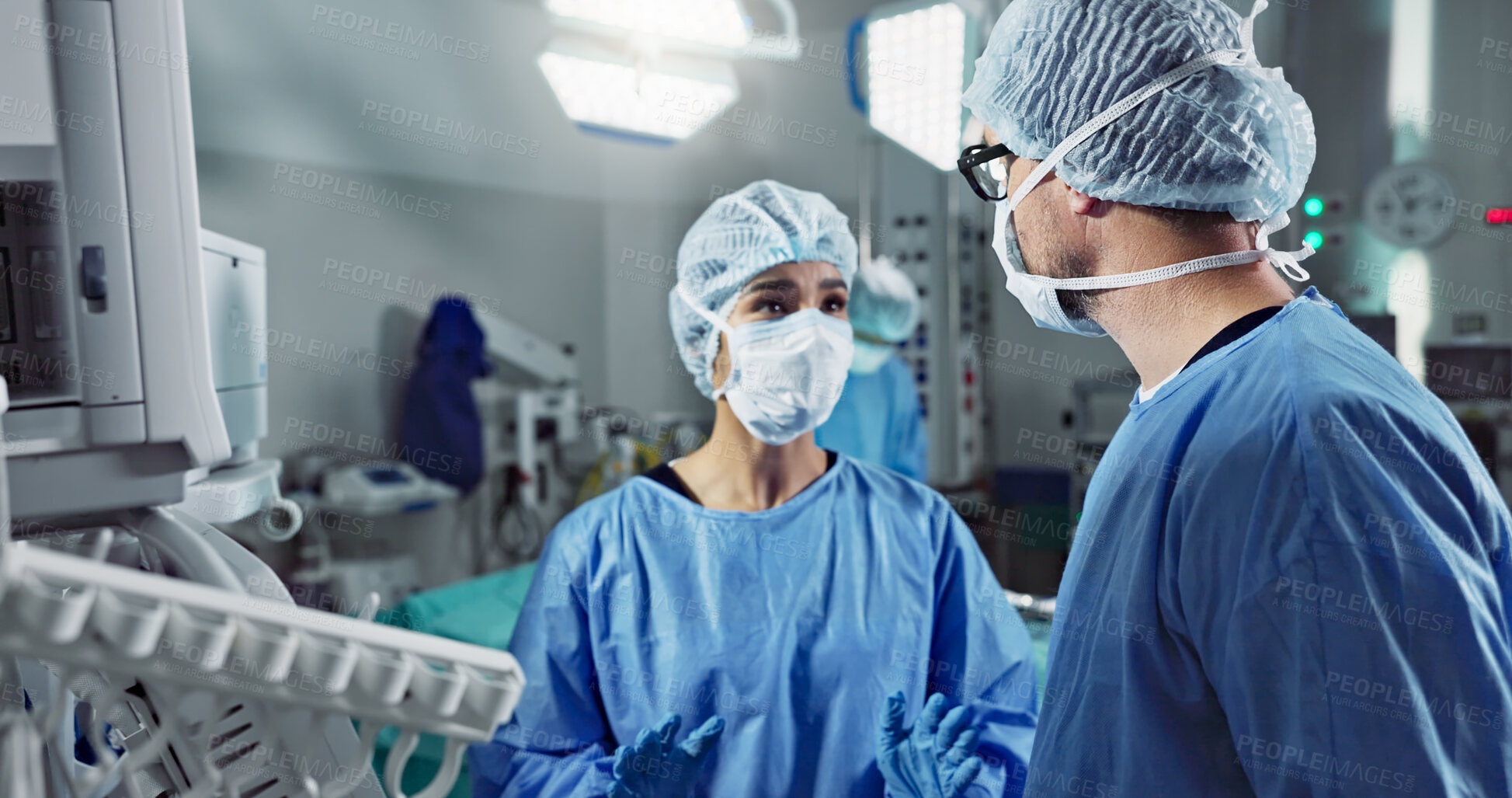 Buy stock photo Medical team, people and doctor in operating room to talk, strategy and pointing at screen for surgery. Man, woman and scrubs in healthcare with equipment in theatre with monitor for xray of patient