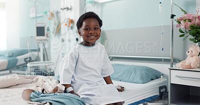 Sick African boy child, hospital and bed with face, smile and rest for recovery from surgery, treatment or healthcare. Patient kid, happy and portrait to relax, sitting and clinic for rehabilitation