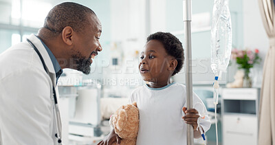 Pediatrician, happy and doctor playing with child as care, support and kindness in healthcare in a hospital or clinic. Iv drip, teddy bear and African professional with medical compassion for kid