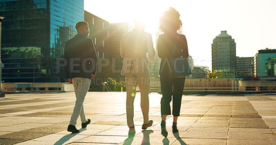 Back, business team and walking outdoor in city for morning travel to work, conversation and lens flare. Rear View, professional workers and moving in urban town with communication and networking