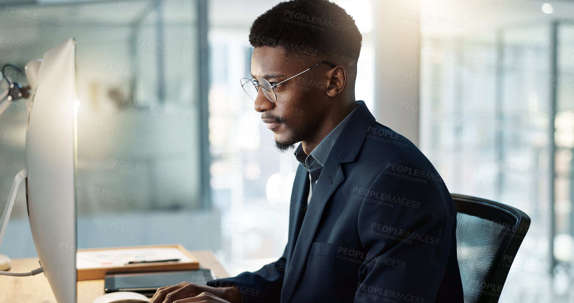 Buy stock photo Thinking, businessman and reading on computer with a smile in office for email, feedback or communication. Working, online or black man with research, inspiration or ideas from Nigeria report or news