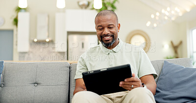 Technology, mature man with tablet and in living room of his home happy for social media. Online communication or networking, connectivity or leisure and black male person on couch with smile