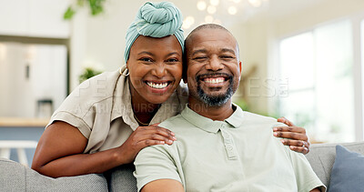 Black couple, relax and smile on a home sofa for happiness, love and care in a living room. Face of an African woman and man together for affection, portrait and hug or comfort in a happy marriage