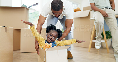 Father, playing and child in a box while moving house with a black family together in a living room. Man and a girl kid excited about fun game in their new home with a smile, happiness and energy