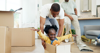 Father, child and playing in a box while moving house with a black family together in a living room. Man and a girl kid excited about fun game in their new home with a smile, happiness and adventure