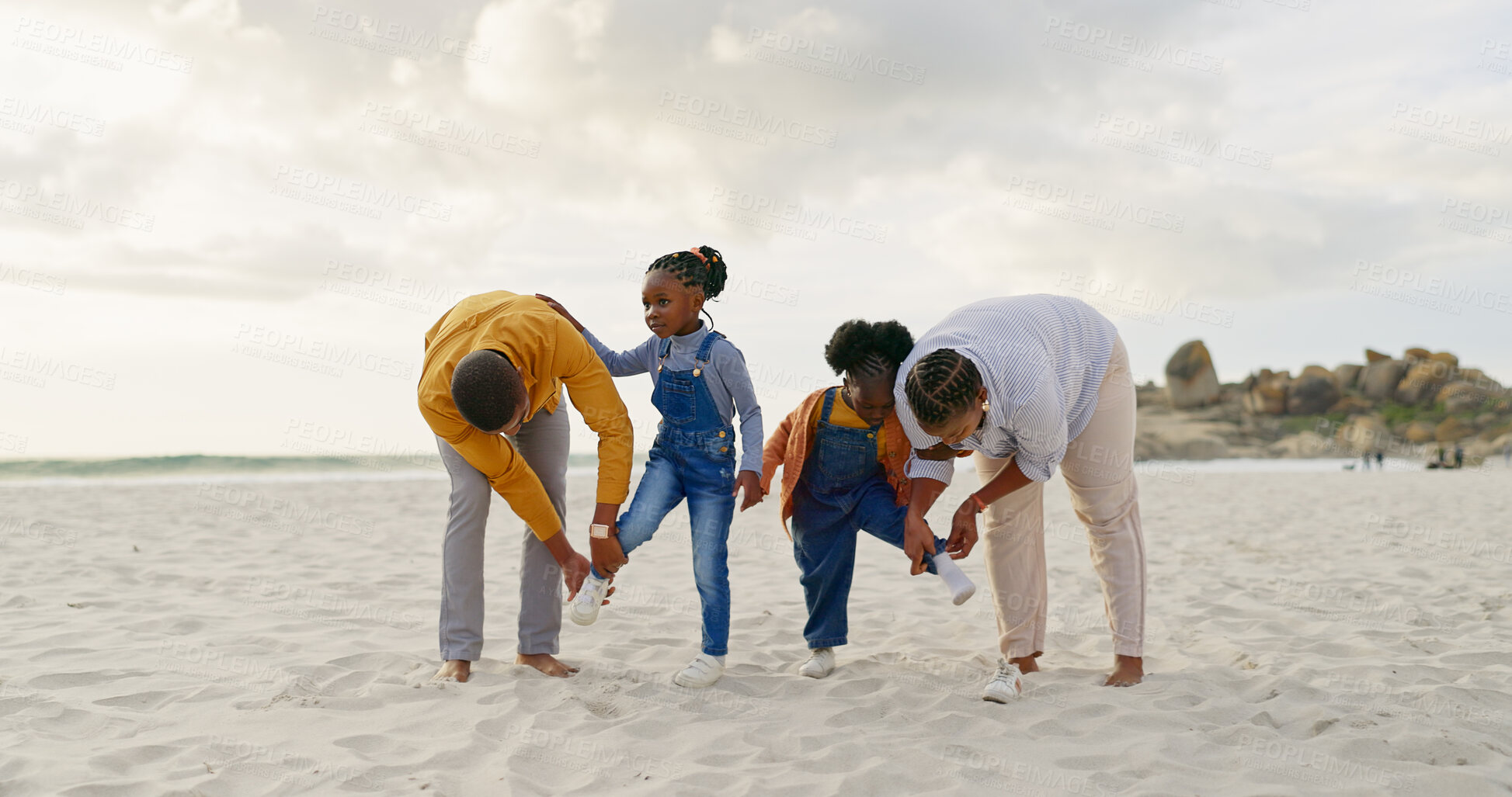 Buy stock photo Summer, sand and a black family at the beach with shoes for walking or running together. Happy, travel and African children with parents getting ready for playing by the sea during a holiday