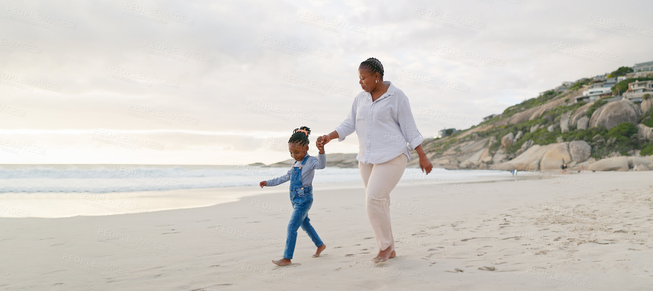 Buy stock photo Black family, mother and daughter holding hands, walk on beach and bonding with love and care outdoor. Happiness, freedom and travel, woman and young girl on holiday with trust and support in nature