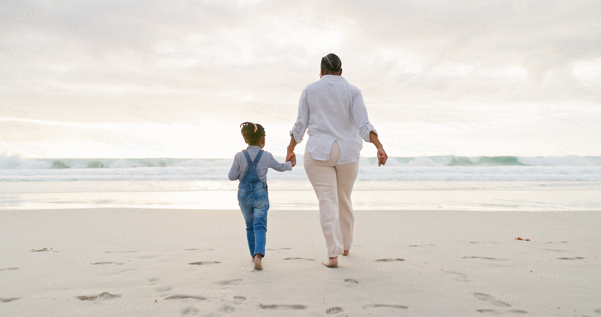 Buy stock photo Black family, mother and daughter holding hands, beach and bonding with love and care, back view and walk outdoor. Sea, freedom and travel, woman and girl on holiday with trust and support in nature
