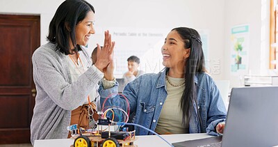 Learning, teacher and high five of student on laptop in classroom, achievement or goal in robotics. Engineering, computer and teenager celebrate success, happy girl and study education at high school