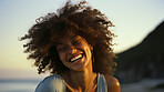 Woman laughing on beach. Happy african american woman at sunset.