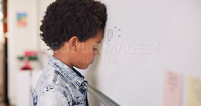Buy stock photo Math class, sad child at board for education, learning and problem solving for skill development. Boy at whiteboard in classroom with struggle, thinking and stress at school for solution in knowledge