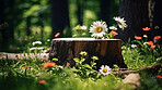 Tree stump with flowers in green forest with copyspace. New life concept