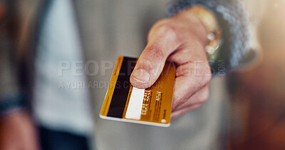 Buy stock photo Cropped shot of an unrecognizable young man handing over a credit card in a shop