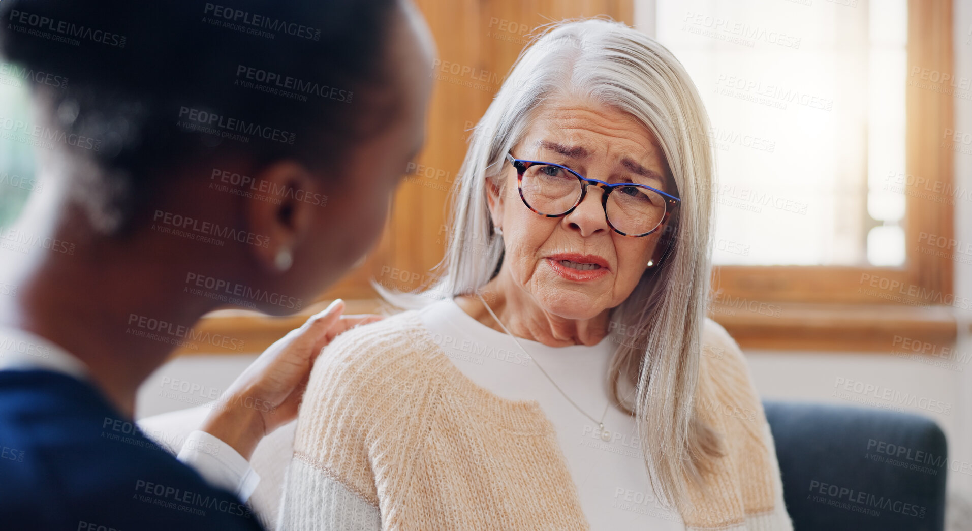 Buy stock photo Senior, sad woman speaking or nurse with support or results in consultation for bad news or cancer. Stress, depression or caregiver with a crying mature patient for empathy, sympathy or help in home