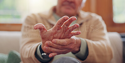 Closeup, hands and senior man with wrist pain, injury and inflammation with bruise, home and broken. Zoom, pensioner and elderly guy on a couch, fingers with ache and arthritis with sprain and strain