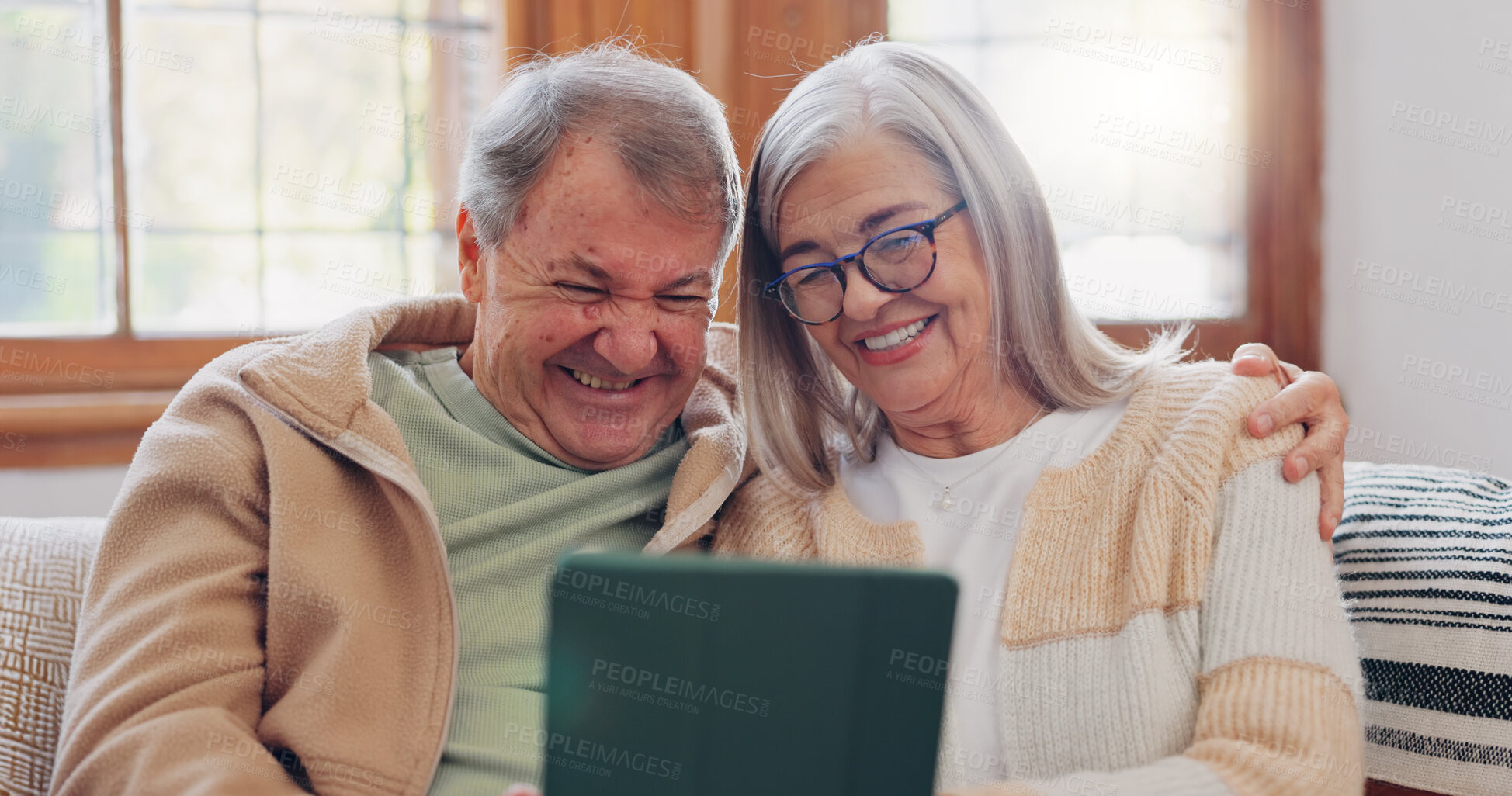 Buy stock photo Tablet, conversation and senior couple on sofa in the living room networking on social media. Digital technology, bonding and elderly people in retirement scroll on mobile app or the internet at home