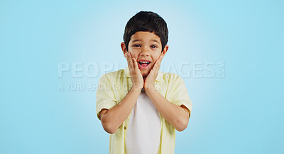 Buy stock photo Smile, kid and hands on face for surprise in studio isolated on a blue background mockup space. Portrait, wow and happy child shocked at good news, promo announcement and excited facial expression