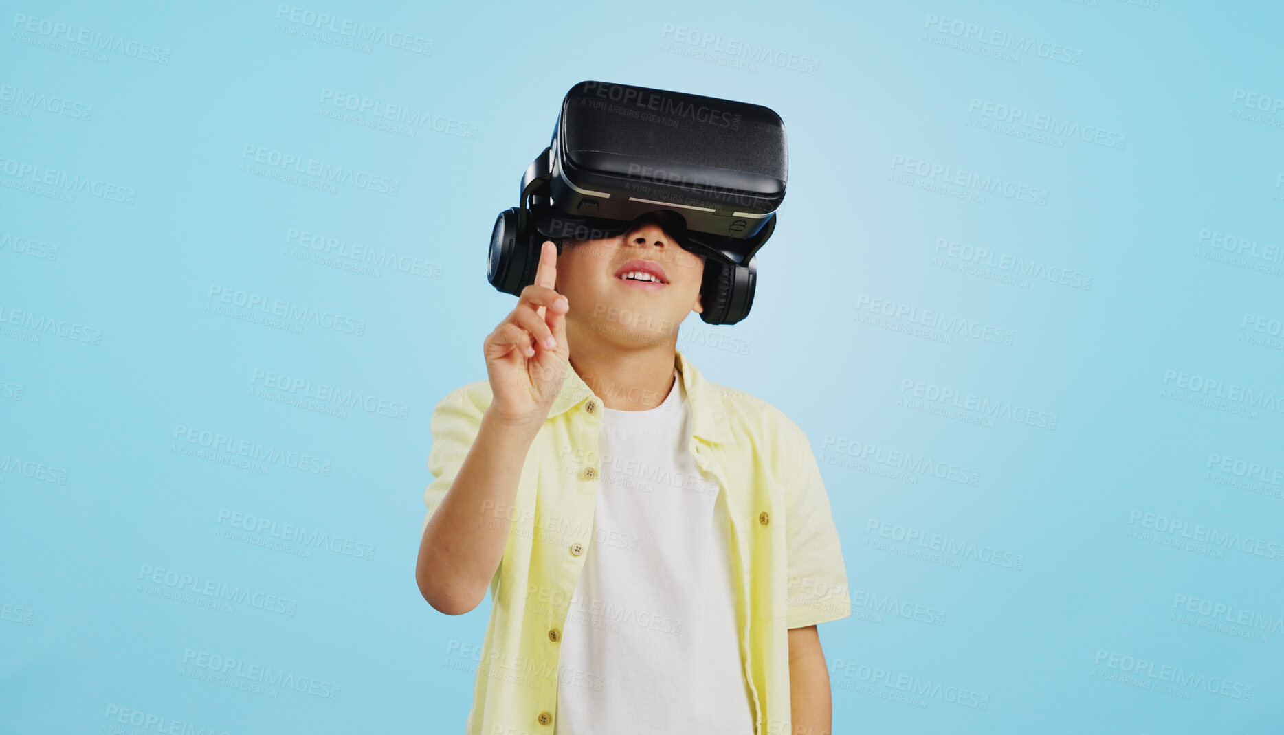 Buy stock photo VR, child and glasses with video gaming, technology and metaverse online in studio. Young boy, gamer and augmented reality app for streaming and virtual graphic on internet with blue background