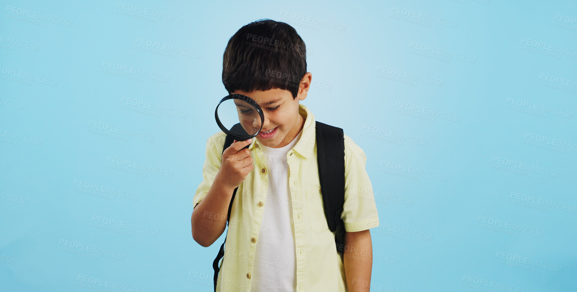 Buy stock photo Search, looking and a child with a magnifying glass on a blue background for inspection or education. Studying, learning and a boy kid with tools for research, detective work or curious with a lens