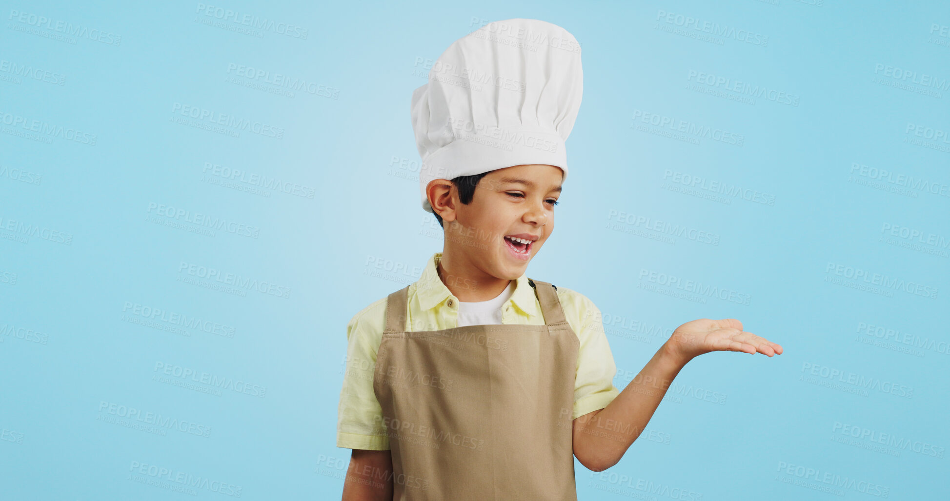 Buy stock photo Child, happy face and chef hand to show promotion, advertising or deal in studio. Dress up, profession and young boy happy from future career of cooking and open palm for sale with blue background