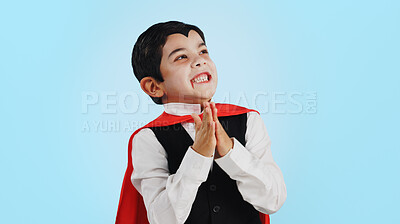 Buy stock photo Choice, halloween and excited child in costume ready for event, hungry and isolated in a studio blue background. Option, checklist and funny young kid with comedy, joy and happiness for holiday