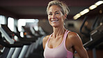 Portrait of fit mature female in gym. Confident smile.