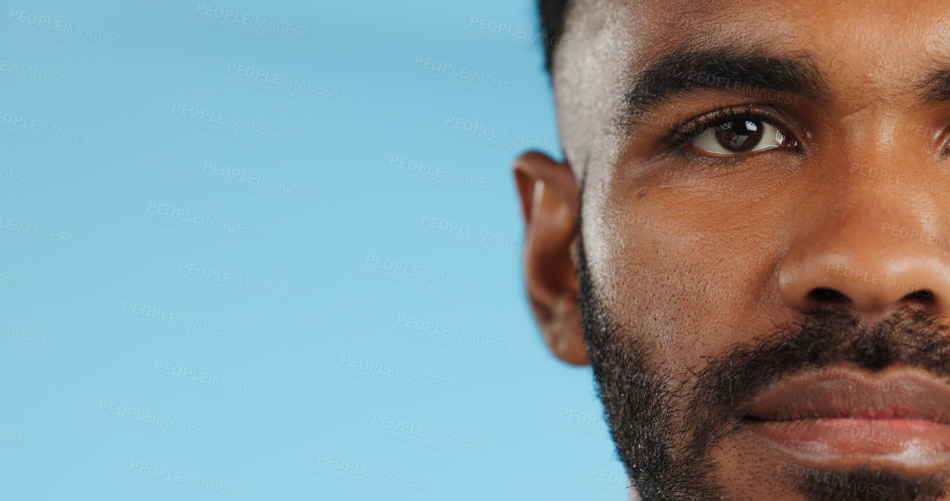 Buy stock photo Half, face and serious black man in studio, blue background and mockup space with confidence or advertising. Portrait, closeup and marketing for skincare, wellness or healthy dermatology care