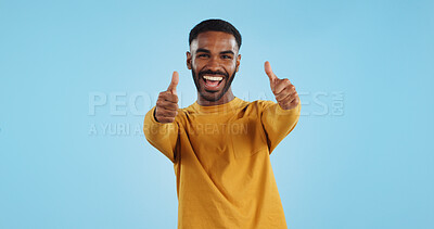 Buy stock photo Happy, face and man with thumbs up in studio for support, motivation or vote on blue background. smile, portrait and excited male model with hand emoji for winning, thank you or success gesture