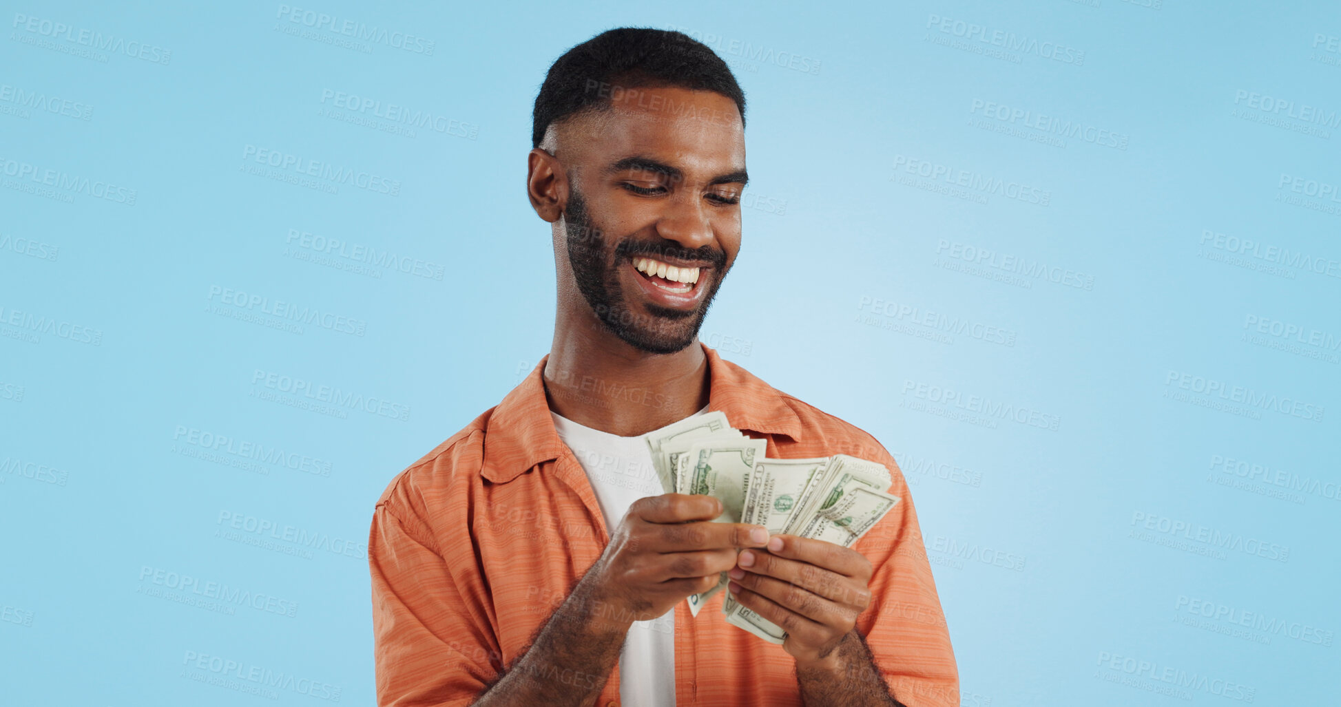 Buy stock photo Man, count money and happy in studio with success, bonus or dollar promotion with winning by blue background. Investor, trader or person with cash, salary or savings with smile for financial freedom goal