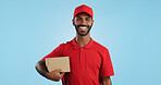 Happy man, box and delivery in transport service, package or order in studio against a blue background. Portrait of male person or courier guy smile with parcel, cargo or logistics on mockup space
