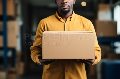 Worker holding boxes or packages in warehouse.