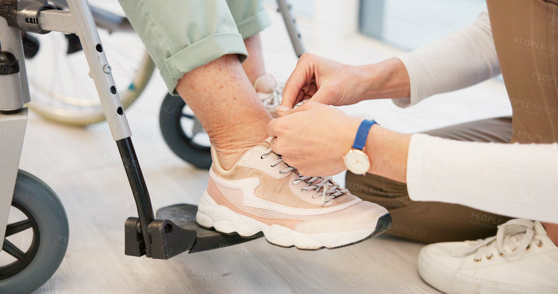 Buy stock photo Caregiver, help and senior woman in wheelchair with shoes in closeup for comfort, care. Nurse, hand and sneakers for elderly person with disability in retirement home for support with medical worker.