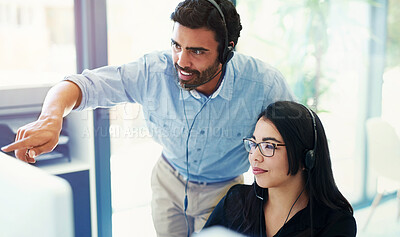 Buy stock photo Cropped shot of two call centre agents working together in an office
