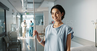 Iv drip, patient and portrait of happy woman in a hospital or clinic corridor with treatment for recovery from surgery. Intravenous, medicine and person with medical insurance for care and health