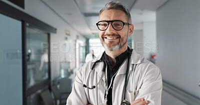 Doctor in portrait, senior man with arms crossed and healthcare, smile with confidence at hospital with pride and help. Medical professional, trust and happy at clinic with expert and stethoscope
