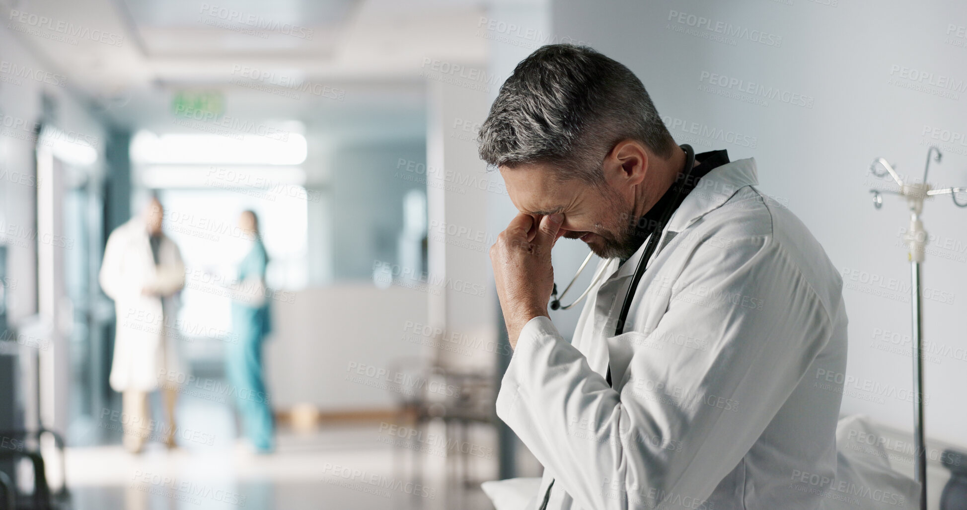 Buy stock photo Stress, grief or fail with a mature doctor in a hospital looking unhappy for healthcare or medical. Depression, mistake or loss with a sad man medicine professional in a professional medicare clinic