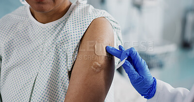 Doctor, hands and bandage on arm, vaccine and healthcare of patient in hospital. Nurse, plaster and injection of person closeup for medicine, virus immunity or help with treatment of injury in clinic