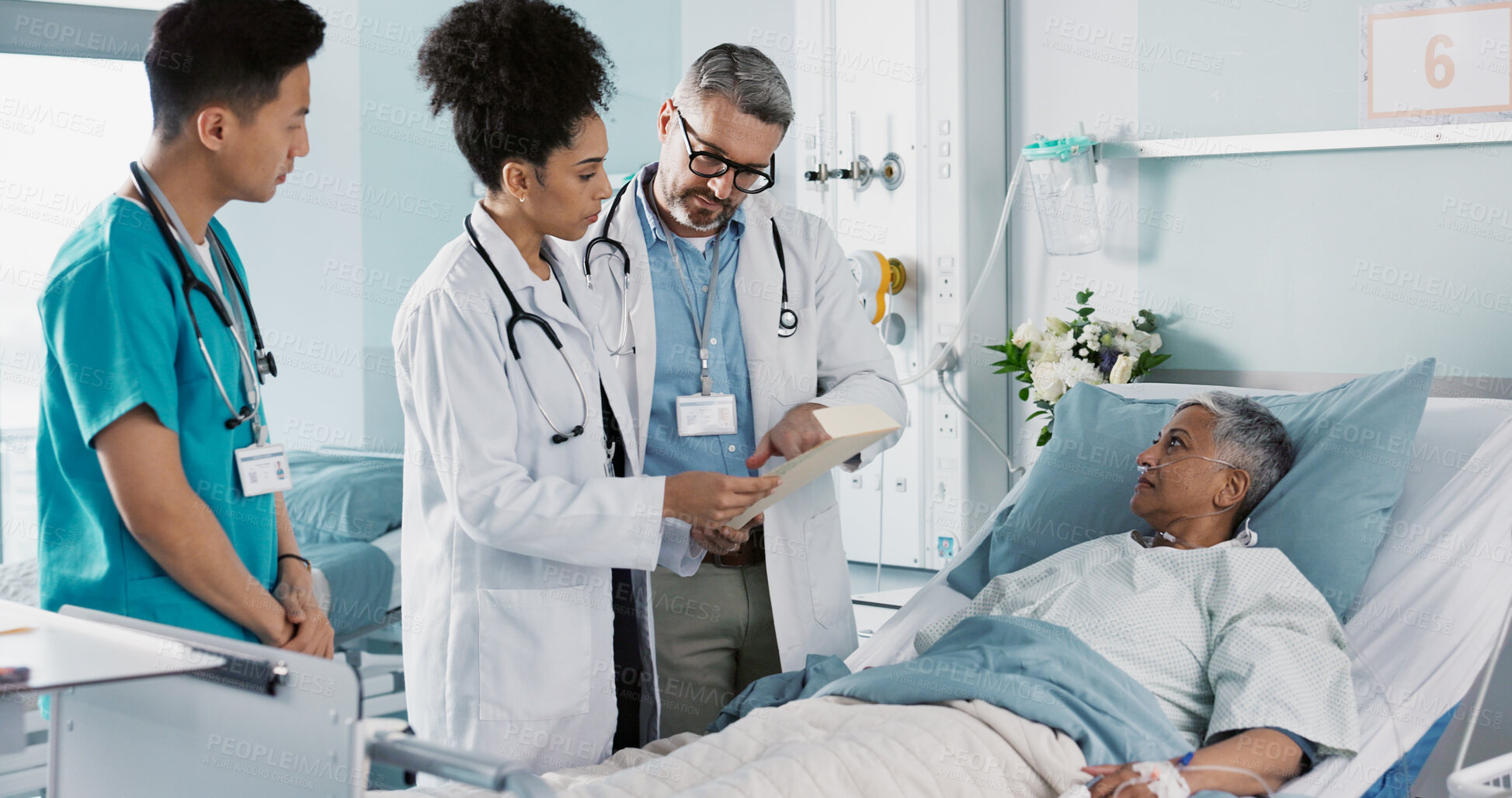 Buy stock photo Healthcare, documents and a medical team of doctors checking on a patient in recovery or rehabilitation. Medicine, teamwork and explain with a group of health professionals in a hospital for wellness