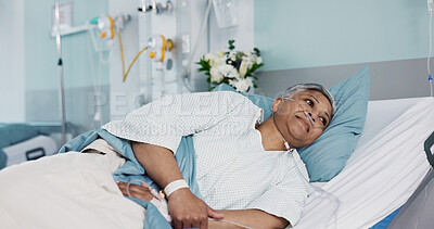 Healthcare, sick and senior woman in the hospital for consultation, surgery or treatment. Medical, recovery and elderly female patient resting in bed on iv drip after operation or procedure in clinic